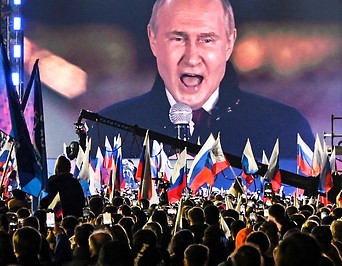 Russischer Präsident Putin auf einer Videoleinwand während einer Ansprache