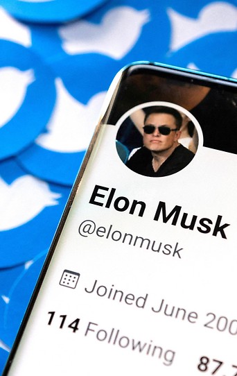 Illustration zeigt das Twitter-Profil von Tesla-Chef Elon Musk auf mehreren gedruckten Twitter-Logos