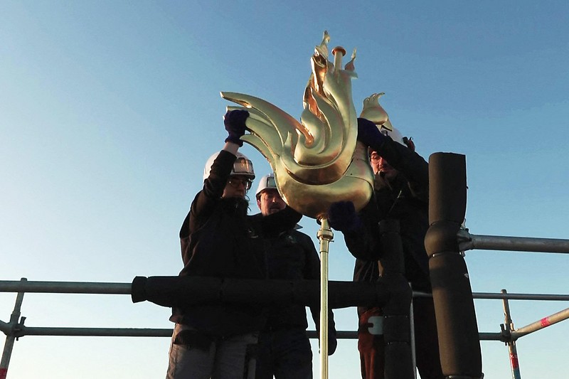 A golden rooster statue is installed on top of Notre Dame Basilica 