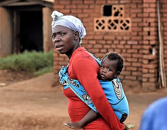 Eine Frau trägt in der malawischen Hauptstadt Lilongwe ein Kind
